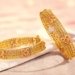 Four Gold Bangles to Add Charm to Your Wrists