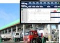A Sicuro Technology fleet management dashboard displaying fuel efficiency, mileage, driver behavior scores, and real-time vehicle analytics over an industrial fuel terminal.