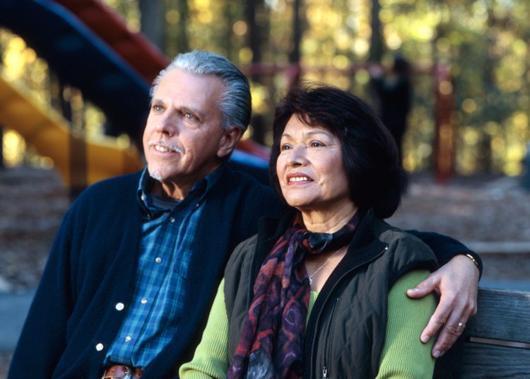 Older couple sitting on a park bench, illustrative retirement photograph by Rhoda Baer, National Cancer Institute