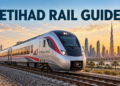 Illustration of an Etihad Rail passenger train on tracks with Dubai’s skyline behind it and the text Etihad Rail Guide.