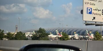 Emirates passenger aircraft parked at Dubai International Airport, UAE, under a partly cloudy sky; archival photograph, not depicting October 2026 conditions