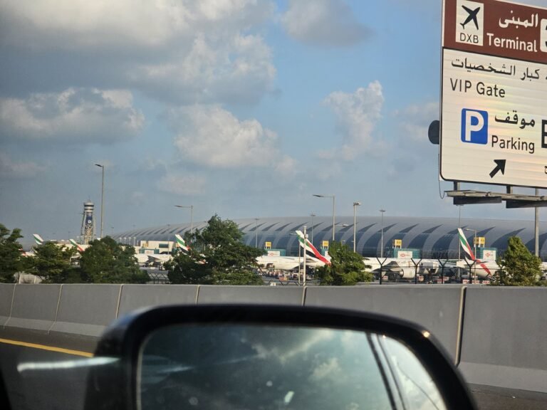 Emirates passenger aircraft parked at Dubai International Airport, UAE, under a partly cloudy sky; archival photograph, not depicting October 2026 conditions
