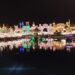 Illuminated Global Village Dubai pavilions reflected in water at night, archival 2023 photograph