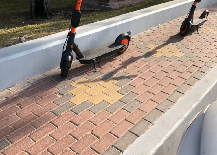 Electric kick scooters parked on a pavement in Abu Dhabi in February 2020