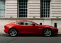 Red Ferrari sports car parked on a city street