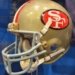 Authentic archival San Francisco 49ers gold football helmet on display, not from October 2026 game
