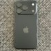 Actual black Apple iPhone 18 Pro photographed from the rear in September 2026, showing triple-camera module