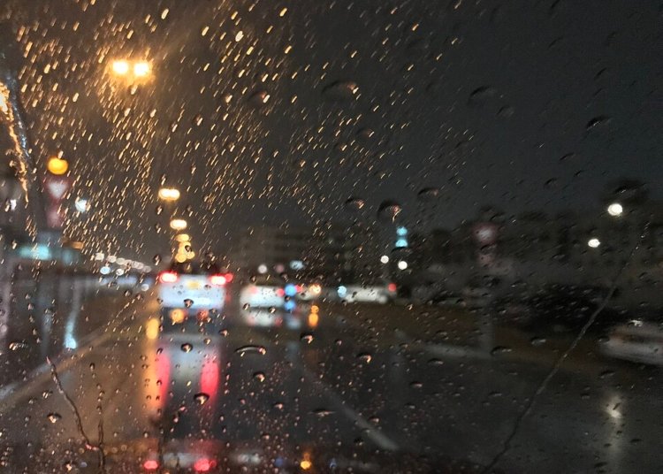 Archive photograph of rain on a Dubai road at night