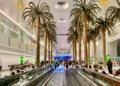 Dubai airport terminal moving walkway with passengers, illustrating Dubai visit visa travel