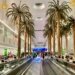 Dubai airport terminal moving walkway with passengers, illustrating Dubai visit visa travel