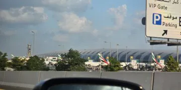 Emirates passenger aircraft parked at Dubai International Airport, UAE, under a partly cloudy sky; archival photograph, not depicting October 2026 conditions