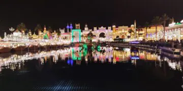 Illuminated Global Village Dubai pavilions reflected in water at night, archival 2023 photograph